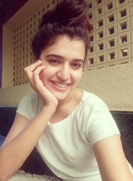 A person smiling warmly, representing a dignified Delhi trans chat community